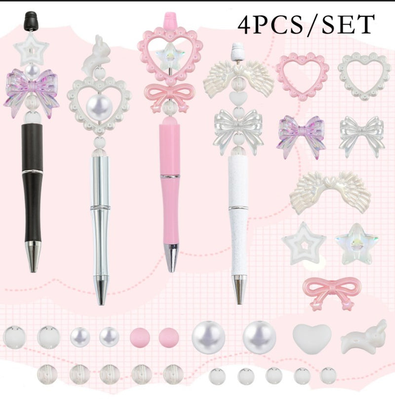 Pearl and bow beadable pen kit - four black, silver, pink and white pens with pearl heart frames, iridescent bows, angel wings and star acrylic beads